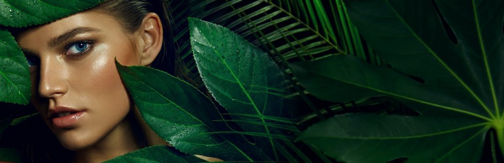 A woman hiding behind leaves