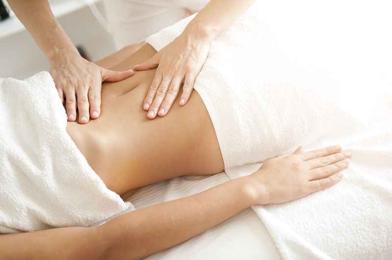 Massaging the treated area after CoolSculpting